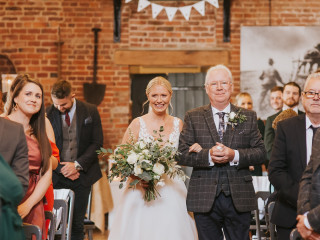 Bride accompanied down the aisle